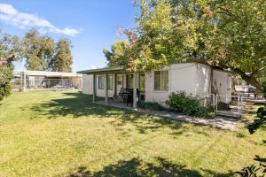 a small white house with a yard at Charming 2-BR Farmhouse Backyard Views in Mesa