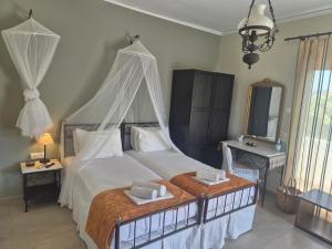 a bedroom with a large bed with a canopy at Villa Niki in Serifos Chora +11 photos