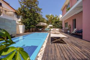 a swimming pool on a wooden deck next to a building at VILLA OLIMPIA Mondello in Mondello +46 photos