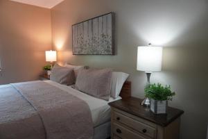 a bedroom with a bed and two lamps on a night stand at River Place Condos #401 2BD in Pigeon Forge +25 photos