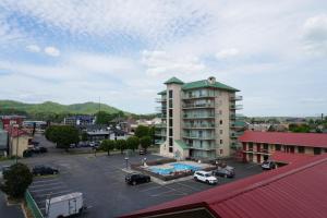 a building in a parking lot with a pool at River Place Condos #401 2BD in Pigeon Forge