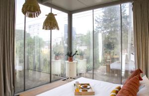 a room with a large glass window with a bed at Casa JuliAna in Mexico City