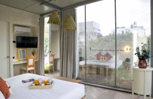 a bedroom with a large window with a view of a room at Casa JuliAna in Mexico City