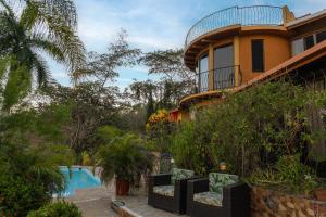 a house with a swimming pool next to a resort at Montezuma Heights in Montezuma