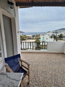 a balcony with a chair and a view of the ocean at Villa Niki in Serifos Chora
