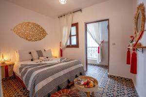 a bedroom with a bed and a large window at Riad HAFSSA & Spa in Marrakesh +24 photos