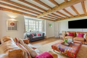 a living room with couches and a flat screen tv at 6 Bed in Hadlow Down oc-g36329 in Hadlow Down