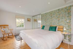 a bedroom with a large white bed and a chair at 6 Bed in Hadlow Down oc-g36329 in Hadlow Down +29 photos