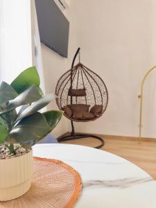 a room with a chair and a table with a plant at Onny's Palace in Bari