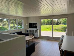 a living room with a couch and a table at VE160-Vejers-Strand-Engesovej-69 in Vejers Strand +12 photos