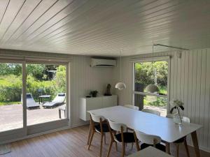 a dining room with a white table and chairs at VE160-Vejers-Strand-Engesovej-69 in Vejers Strand