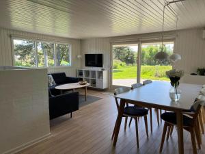 a living room with a table and a dining room at VE160-Vejers-Strand-Engesovej-69 in Vejers Strand
