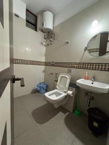 a bathroom with a toilet and a sink at Nirvana Yogashala Retreat in Mysore +15 photos