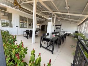 a dining room with a table and chairs and plants at Nirvana Yogashala Retreat in Mysore