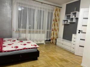 a bedroom with a bed and a dresser and a window at Rooms near Balice airport in Cholerzyn +11 photos