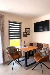 a dining room with a table and two chairs at Gemütlicher Bungalow bei Aalen,Abtsgmünd in Abtsgmünd