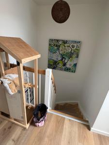 a room with a staircase with a bunk bed and a table at Rolig base under smukfest in Skanderborg +3 photos