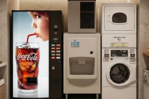 a soda machine with a picture of a child with a drink at Townhouse Fort Walton Beach Hurlburt Field in Mary Esther