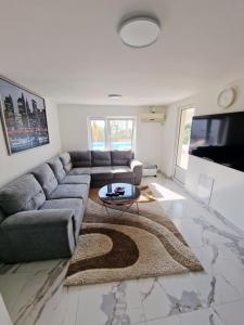 a living room with a couch and a table at Villa Bavaria in Ritopek