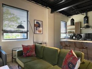 a living room with a couch and a kitchen at Classic Pied a Terre in Benton Harbor