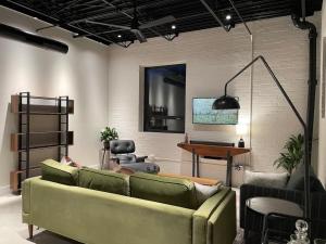 a living room with a couch and a piano at Classic Pied a Terre in Benton Harbor