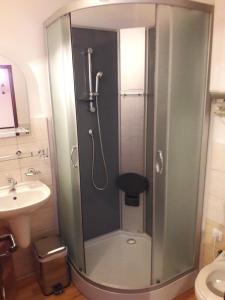 a shower with a glass door in a bathroom at Penzion Oáza Hřensko in Hřensko +18 photos