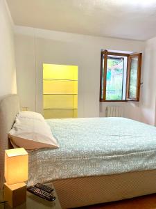 a bedroom with a bed and a window at Ninfea Como Lake - La casa del viandante in Bellano