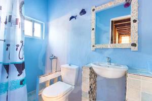 a bathroom with a toilet and a sink and a mirror at Villa Markella in Chrysi Ammoudia +26 photos