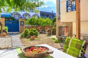a bowl of fruit sitting on a table in front of a house at Villa Markella in Chrysi Ammoudia
