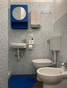 a bathroom with a toilet and a sink and a mirror at Ninfea Como Lake - La casa del viandante in Bellano +25 photos