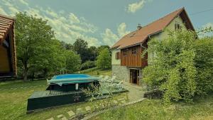 a boat sitting on a deck next to a house at House Toni by Villas Guide in Brod Moravice