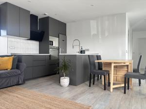 a kitchen and living room with a table and a couch at Bio Home La Asomada in Tías +28 photos