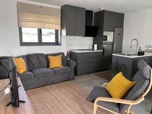 a living room with a couch and a kitchen at Bio Home La Asomada in Tías