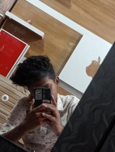 a man taking a picture of himself in a mirror at Parijat Talpuri rishali in Durg
