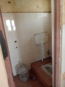 a dirty bathroom with a sink and a toilet at Parijat Talpuri rishali in Durg
