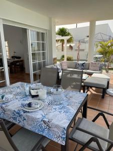 a dining room table with a blue and white table cloth at Casa Alegria in Puerto Rico de Gran Canaria