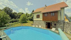 a swimming pool in front of a house at House Toni by Villas Guide in Brod Moravice