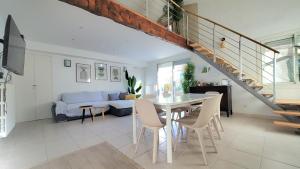 a living room with a table and a couch at VILLA EN PROVENCE AVEC PISCINE AU CALME À ARLES - Camargue in Arles