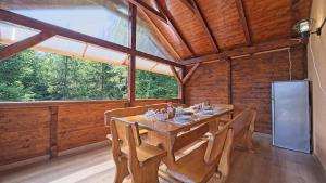 a dining room with a table and a refrigerator at House Kiki by Villas Guide in Bosiljevo