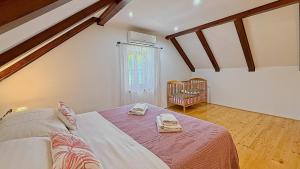 a bedroom with a bed with two towels on it at House Toni by Villas Guide in Brod Moravice +38 photos