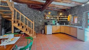 a kitchen with a staircase in a stone wall at House Toni by Villas Guide in Brod Moravice