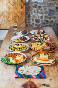 a table with many plates of food on it at Eco-Hotel Mayachik in San Juan La Laguna