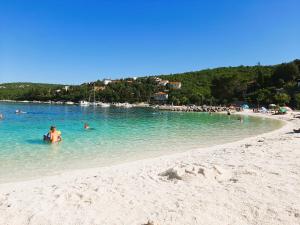 a group of people in the water at a beach at Apartma Dana in Jadranovo