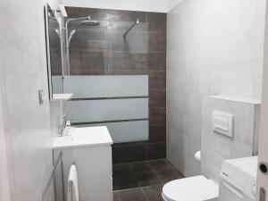 a white bathroom with a sink and a toilet at Apartma Dana in Jadranovo +24 photos