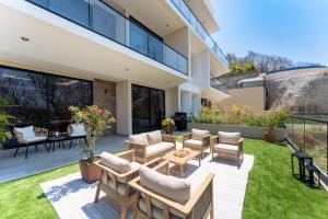 a patio with chairs and tables in a yard at 3101 - Paradise Cove 1A Violin in Tangolunda