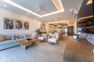 a living room with a couch and a table at 3101 - Paradise Cove 1A Violin in Tangolunda