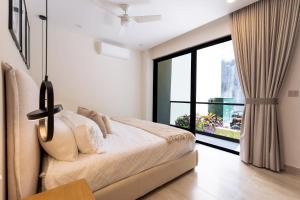 a bedroom with a bed and a large window at 3101 - Paradise Cove 1A Violin in Tangolunda +30 photos