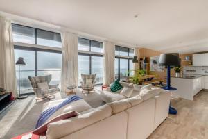 a living room with a white couch and large windows at 4 Bed in Hythe oc-p30519 in Hythe
