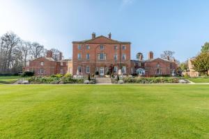 a large brick house with a large green lawn at 2 Bed in Southwell oc-n30605 in Southwell