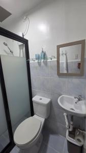 a bathroom with a toilet and a sink at Kim's Cozy Place - Parthenon Residences in Cebu City +25 photos